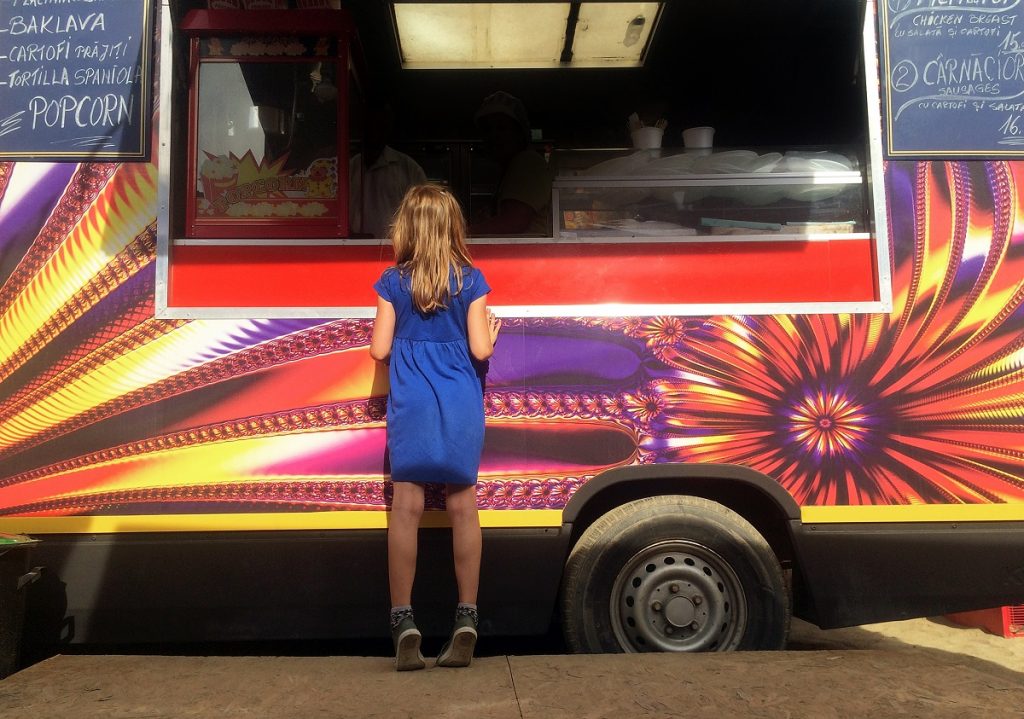 Girl in front of a food truck