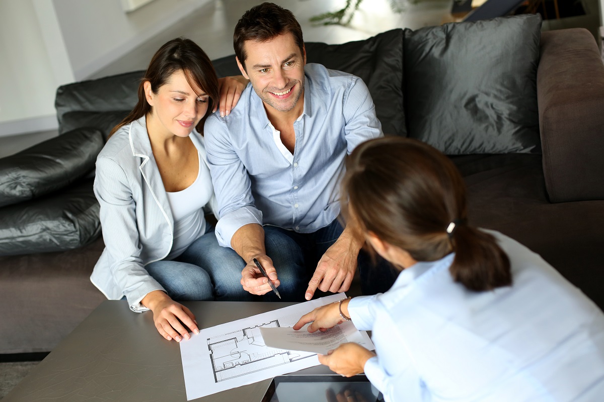 couple talking to real estate agent