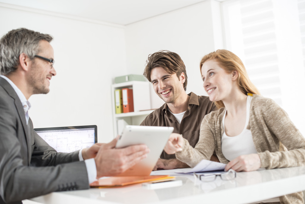 couple talking to real estate agent