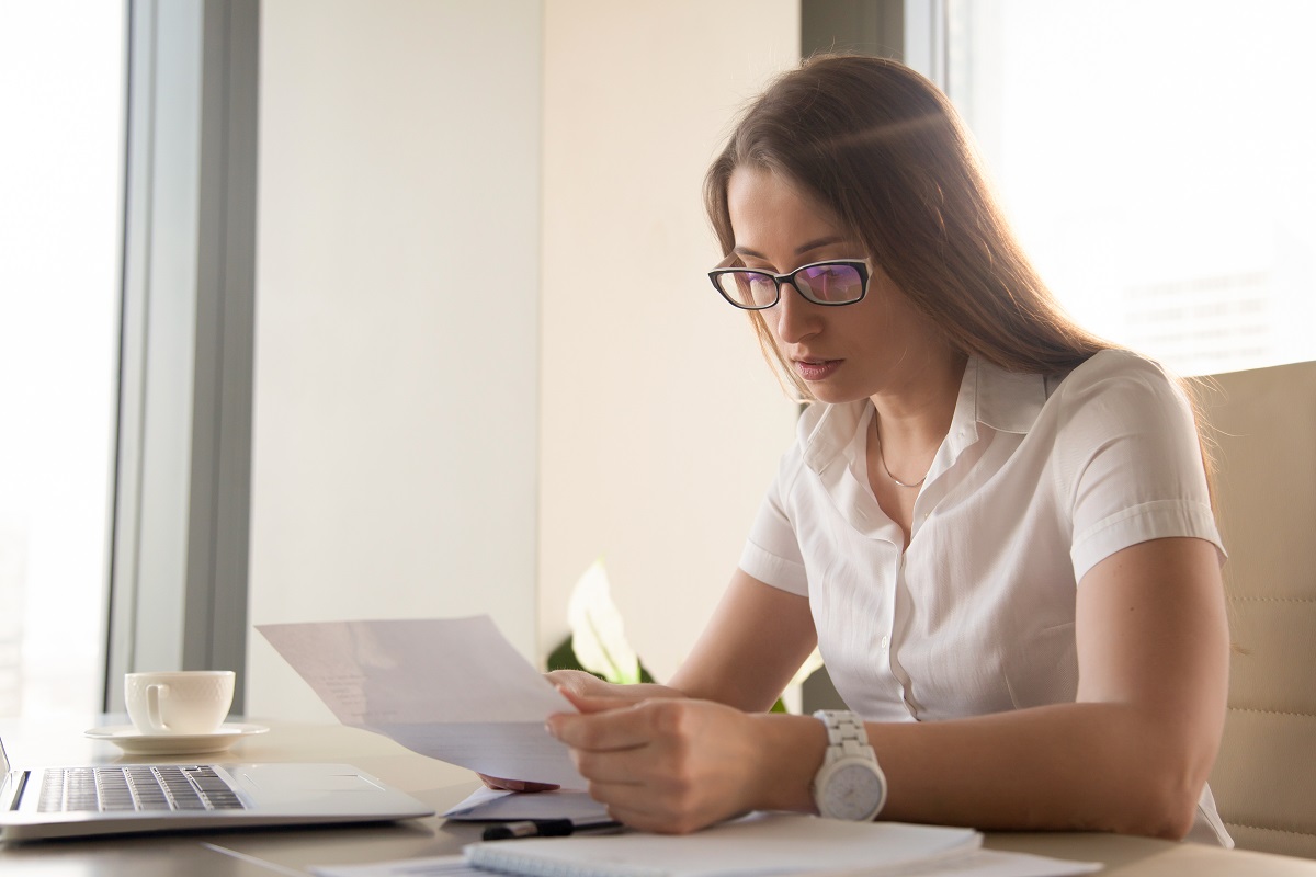 woman looking at paper