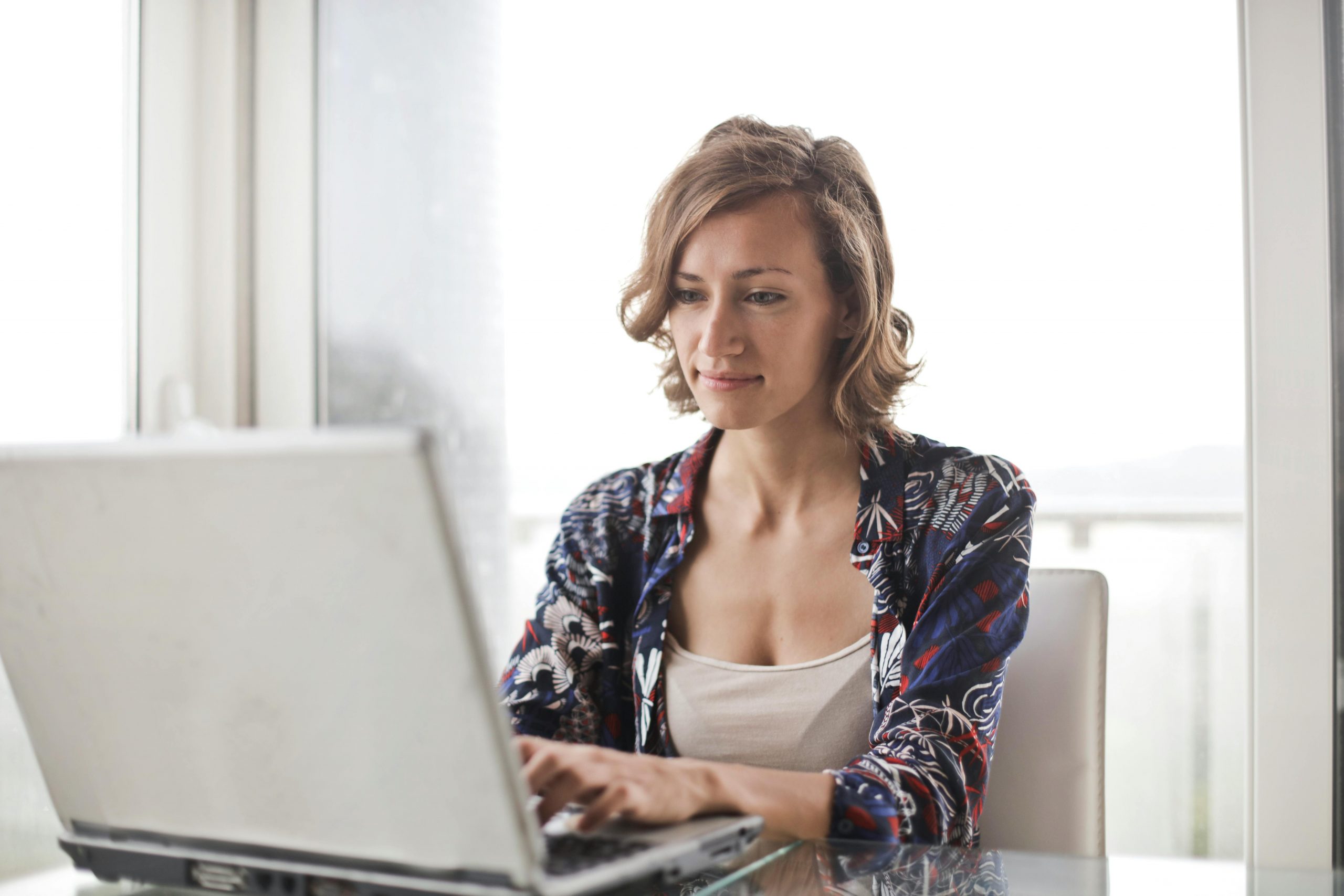 smiling woman working on a laptop